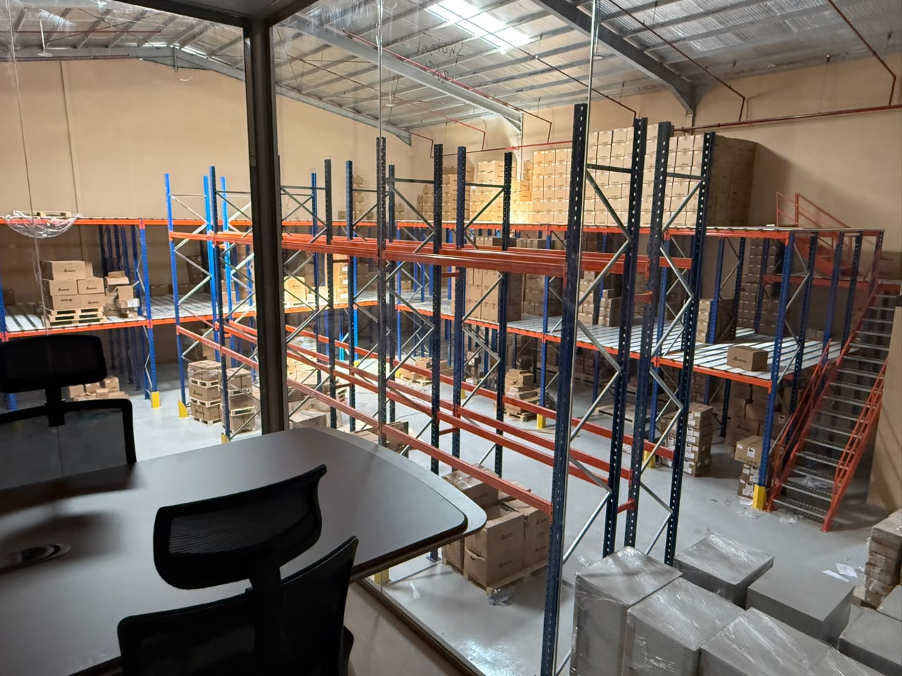Tesla Automation Riyadh warehouse aisle with Delta automation spare parts prepared for delivery across Saudi Arabia